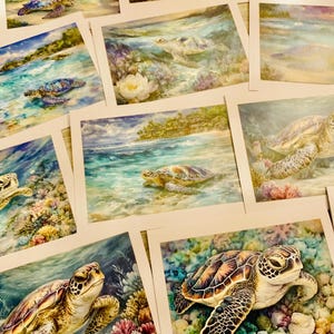 May include: A collection of watercolor art prints featuring sea turtles in their natural ocean habitat. The artwork showcases turtles swimming in turquoise waters, with coral reefs and sandy shores in the background. The prints have a soft, artistic style.