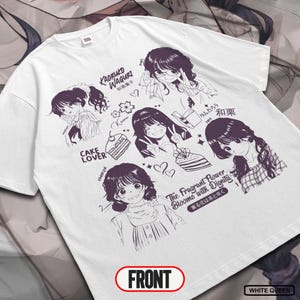 May include: White t-shirt featuring a purple manga-style illustration. The design includes multiple portraits of young women, cake slices, and Japanese text. The word "FRONT" is printed in a red oval at the bottom.