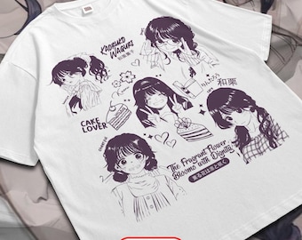 May include: White t-shirt featuring a purple manga-style illustration. The design includes multiple portraits of young women, cake slices, and Japanese text. The word "FRONT" is printed in a red oval at the bottom.