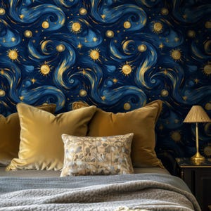 May include: A bedroom scene featuring a bed with mustard-colored pillows and a patterned throw. The headboard wall is covered in a dark blue wallpaper with a swirling, starry night design in gold and yellow. A small lamp sits on a black nightstand.
