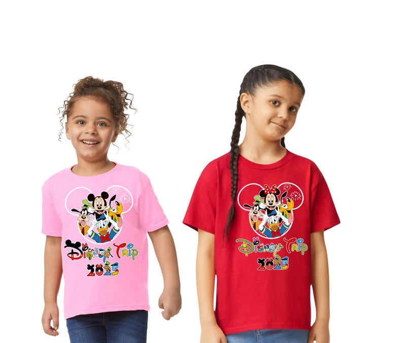 May include: Two children wearing pink and red t-shirts with a Disney Trip 2023 graphic. The graphic features Mickey Mouse, Minnie Mouse, Donald Duck, Goofy, and Pluto inside a Mickey Mouse head outline.