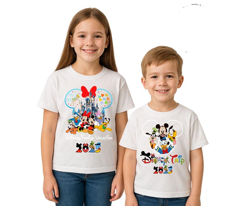 May include: Two children wearing white t-shirts with Disney character designs. The shirts display Mickey Mouse, Minnie Mouse, Donald Duck, and Goofy, with the text "Disney Family Vacation 2025" and "Disney Trip 2025" in colourful lettering.