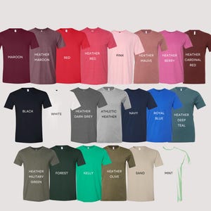 May include: A selection of t-shirts in a variety of colours, including maroon, red, and navy. Each shirt has a colour name printed on it, such as "Maroon," "Red," and "Black." The shirts are arranged in neat rows and columns.