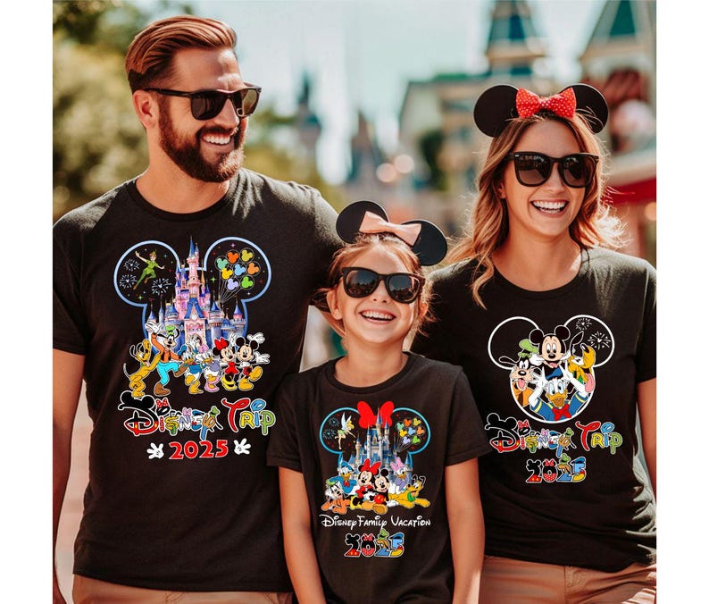 May include: Black t-shirts with Disney character designs. Each shirt features a Mickey Mouse head outline with a castle, characters, and the text "Disney Trip 2025". The family is wearing matching shirts.