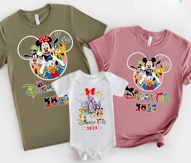 May include: Three Disney-themed tops and a babygrow. The tops are olive green and dusty rose, featuring Mickey Mouse, Minnie Mouse, Donald Duck, Goofy, and Pluto. The babygrow is white with a castle graphic. All items have "Disney Trip 2025" text.