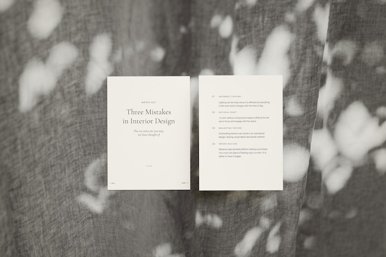 May include: Two open, off-white pages of a booklet titled "Three Mistakes in Interior Design" with text on a gray background. The left page has the title and the right page lists four mistakes. The background has a pattern of white shapes.