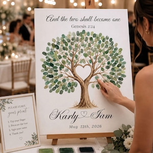 May include: A white wedding guest book canvas featuring a brown tree illustration with green fingerprint leaves forming a heart shape. Text reads: And the two shall become one, Genesis 2:24, Karly & Iam, May 12th, 2026. Includes a sign with instructions.