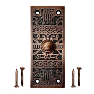 May include: A rectangular copper-toned doorbell push button plate featuring a central circular button and intricate geometric relief patterns against a dark textured background, accompanied by four matching metal mounting screws.
