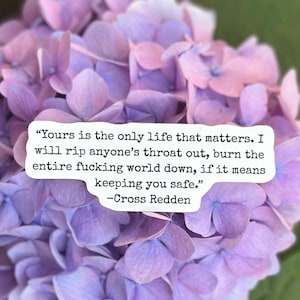 May include: A close-up of a cluster of purple and pink hydrangea flowers. A white rectangular text box overlays the flowers, containing a quote by Cross Redden about protecting oneself, with the text in black.