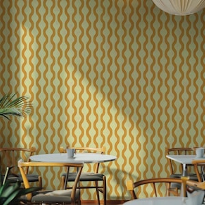 May include: A retro-style wallpaper with a repeating wavy pattern in shades of gold and cream. The design creates a vertical, flowing effect, suitable for interior decor. The image shows a room with tables and chairs.