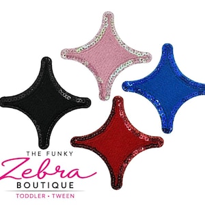 May include: Four star-shaped patches in black, pink, red, and blue. Each patch has a sequined border. The patches are from The Funky Zebra Boutique, with text that reads "Toddler • Tween".