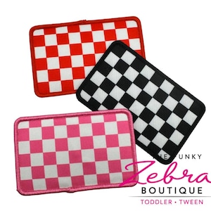 May include: Three rectangular patches with a checkered pattern in red and white, black and white, and pink and white. The patches have a stitched border and are from Zebra Boutique.