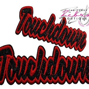 May include: Two embroidered patches with the word "Touchdown" in a script font. The text is black with a red outline. The patches are likely for sports apparel or accessories.