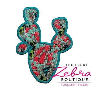 May include: Embroidered cactus patch with a turquoise border. The cactus design features a mix of red, teal, black, and gray patterns. The Funky Zebra Boutique logo is in the bottom right corner, with the words "Toddler • Tween" below.
