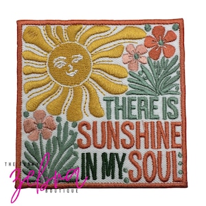 May include: Embroidered patch with a smiling sun, flowers, and the text "THERE IS SUNSHINE IN MY SOUL." The patch features a white background with orange, yellow, green, and pink accents. The patch is square with an orange border.