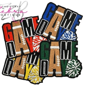 May include: Embroidered patches in various colors spelling "GAME DAY" with football and pom-pom designs. Patches include red, brown, blue, green, and yellow. The patches are outlined in black.