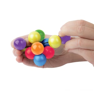 May include: A collection of colorful, round beads in various colors, including purple, yellow, green, orange, red, and blue. The beads are held in a person's hand, suggesting a tactile or sensory toy. The beads are strung together on a black string.