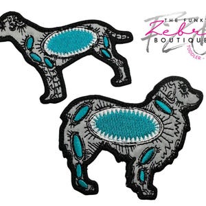 May include: Two dog-shaped patches. The patches are gray with black outlines and turquoise accents. The patches have an oval turquoise center and smaller turquoise shapes. The text "THE FUNKY ZEBRA BOUTIQUE" is in the upper right corner.