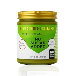 May include: A jar of spreadable pistachio sweet cream with a gold lid. The label is white and green, with text that reads "SPREADABLE PISTACHIO SWEET CREAM" and "NO SUGAR ADDED". The jar contains 8.46 oz (240g).