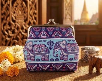 May include: A coin purse with a metal kiss-lock clasp featuring a repeating pattern of elephants in shades of purple, light blue, and white, accented with intricate geometric and floral motifs across the entire surface of the pouch.