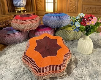 May include: A collection of six star-shaped floor cushions featuring intricate geometric patterns in red, blue, purple, pink, green, and orange. Each cushion has a central button tuft and a textured fabric finish, arranged on a grey rug.