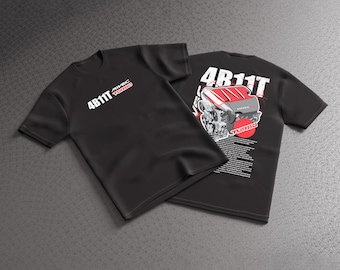 May include: A black short-sleeved t-shirt featuring the white text 4B11T MIVEC TURBO on the front. The back displays a large graphic of a car engine, the text 4B11T, a red circle, and additional small white text detailing engine specifications.