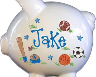 Sports personalized piggy bank in blue, green, brown, and orange to suit any sport enthusiast that makes the perfect baby shower gift