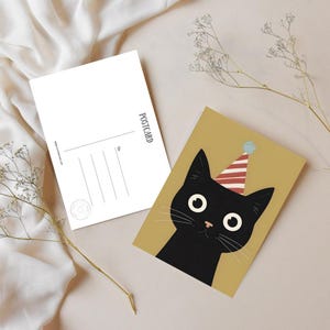 May include: Two postcards. One features a black cat wearing a party hat on a mustard-colored background. The other postcard is blank with the word "POSTCARD" printed vertically. The blank postcard has lines for the recipient's address.