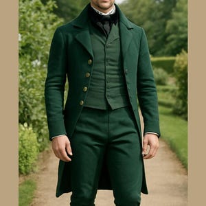 May include: A dark green three-piece suit with a long coat, vest, and matching trousers. The suit features gold-colored buttons and is paired with a black top hat and black shoes. The outfit is completed with a white collared shirt and light-colored socks.