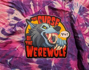 May include: A sticker with a cartoon werewolf snarling with the text "The Curse of the Werewolf" and a speech bubble saying "F#%*!"
