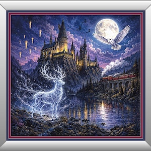 May include: A framed wall art print depicting a glowing, translucent stag standing on a rocky shore near a lake. In the background, a large castle sits on a cliff under a full moon, with a steam train crossing a bridge and a white owl flying.