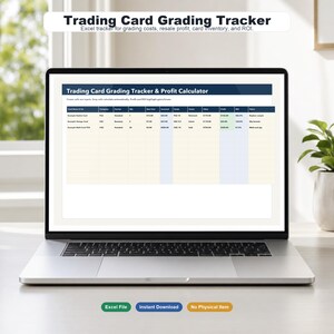 May include: A silver laptop displaying a Trading Card Grading Tracker & Profit Calculator spreadsheet. The screen shows columns for card name, company, service, quantity, cost, invested, grade, status, value, profit, ROI, and notes in a grid format.