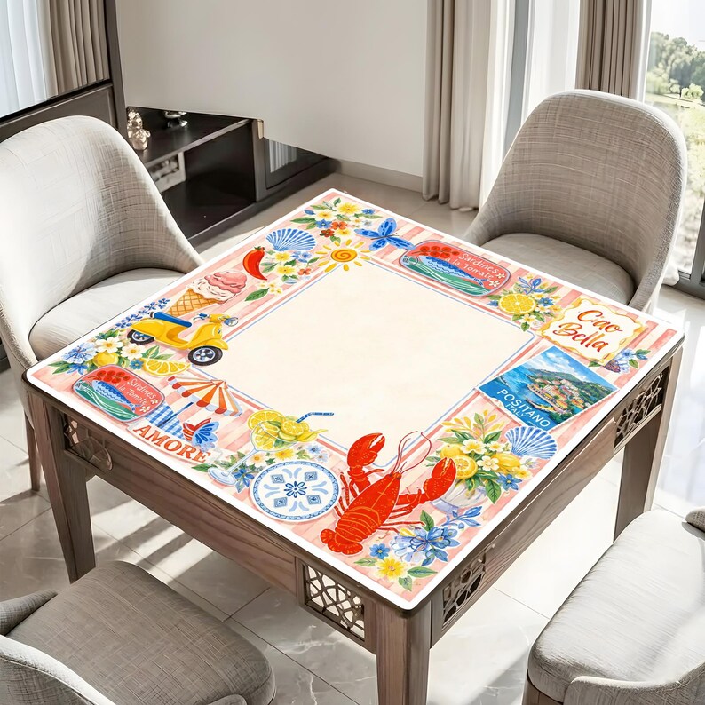 May include: A square wooden table with a decorative top featuring Italian-themed illustrations. The design includes a red lobster, a yellow scooter, ice cream, and the word "Amore". The table is surrounded by chairs.