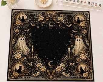 May include: A square black mat featuring a gothic-inspired design with two white ghosts, four black cats in circular frames, gold roses, bows, crescent moons, and lit candles. The border is ornate with intricate floral patterns and spiderwebs.