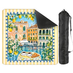 May include: A yoga mat with a watercolour painting of a European cityscape, a table set for coffee and a croissant. The mat has a yellow and white striped border and comes with a black carrying bag.