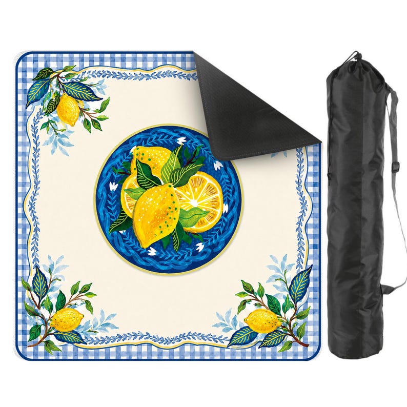 May include: A picnic blanket with a lemon design. The blanket features a blue and white gingham border and a central design of lemons on a blue plate. A black carrying bag is included.