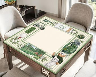 May include: A square table cover featuring a golf-themed design with a cream center, green striped borders, and illustrations of a teddy bear in golf attire, a golf cart, a golf bag, a golf ball, and a scenic landscape with a stone bridge.
