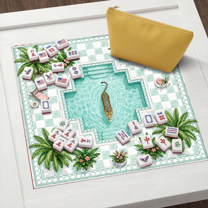 May include: A square mahjong mat featuring a light green and white checkered pool deck design with palm trees, a leopard swimming in the center, and scattered mahjong tiles with various symbols and American flags, accompanied by a solid yellow zippered pouch.