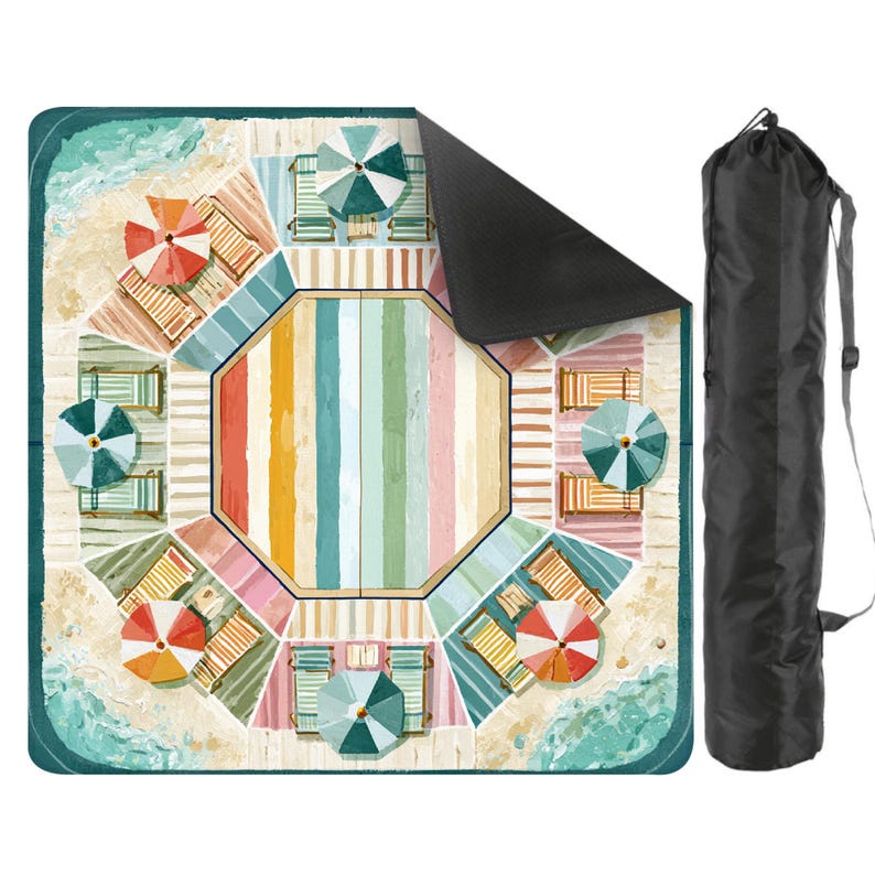 May include: A beach-themed picnic blanket with a colorful design featuring beach umbrellas, lounge chairs, and a central striped pattern. The blanket is rolled up in a black carrying bag with a shoulder strap, perfect for outdoor use.