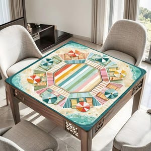 May include: A square wooden table with a beach-themed design. The tabletop features a colorful beach scene with umbrellas, beach chairs, and a striped central design. The table has four legs and decorative cutouts.