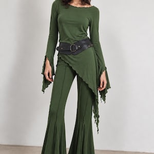 May include: An olive green long-sleeve top with a lettuce-edge neckline and flared sleeves, paired with matching olive green flared pants featuring vertical seams. A wide black textured belt with a central buckle cinches the waist.