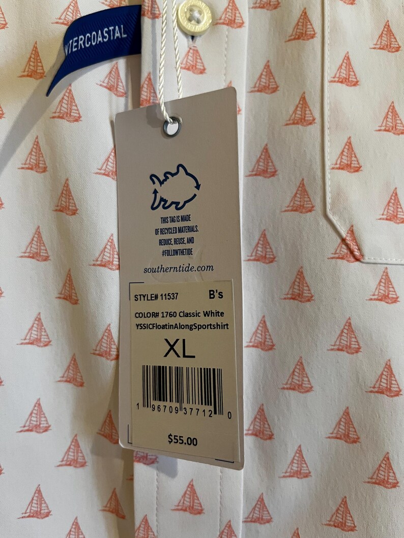 May include: White button-down shirt with a repeating pattern of orange sailboats. The shirt has a tag that reads "INTERCOASTAL" and "southern tide.com". The tag also says "XL" and "YSSICFloatinAlongSportshirt".