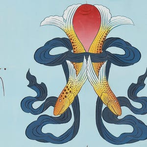 May include: A vibrant illustration featuring two fish with yellow and orange scales, linked by a red and white floral design. Dark blue ribbons weave around the fish against a light blue backdrop. Tibetan script is visible on the left.