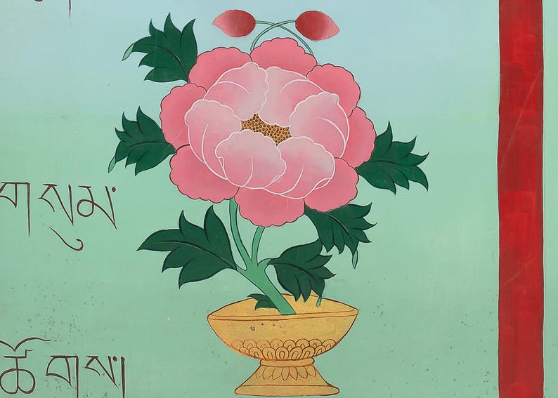 May include: A hand-painted floral artwork featuring a large pink peony in a gold vase, with green leaves and two red buds. The background is a light teal colour with Tibetan script and a red vertical stripe.