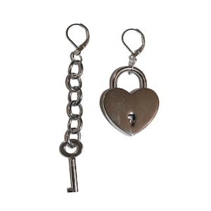 May include: A pair of silver heart-shaped lock earrings with a silver chain and key. The earrings are designed to look like padlocks with a keyhole.