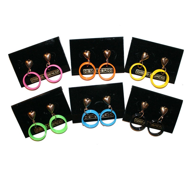 May include: Assortment of eight pairs of heart-shaped dangle earrings with colorful circular hoops. The hoops are in pink, orange, yellow, blue, green, and black.