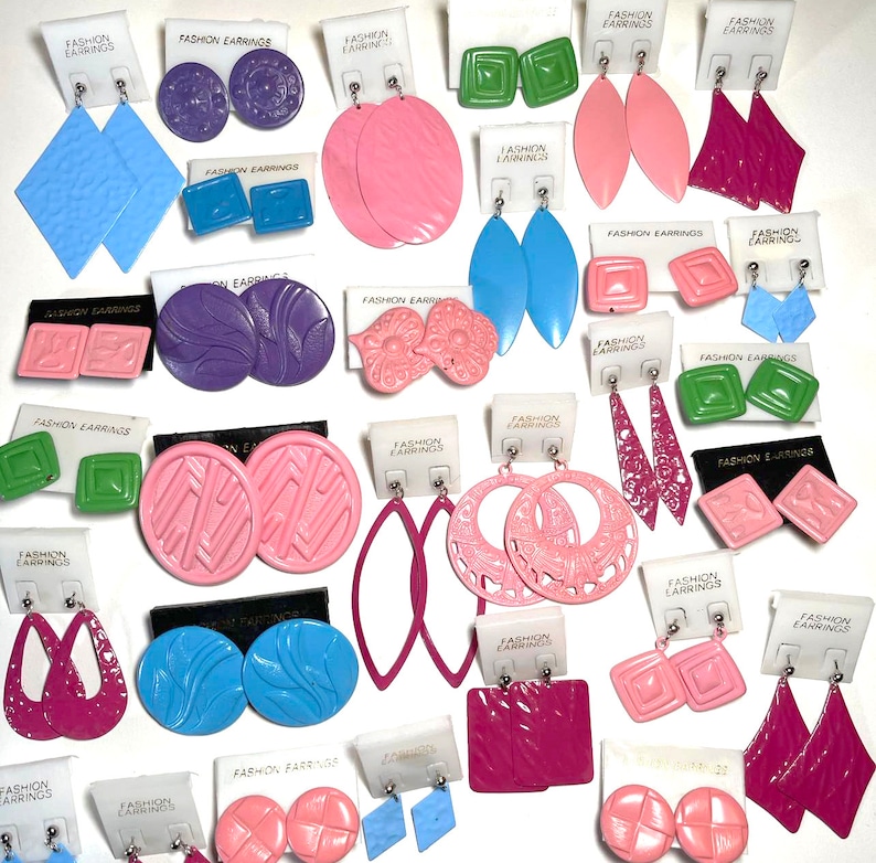 May include: Assortment of colorful plastic earrings on white cards with the text "Fashion Earrings". The earrings are in various shapes, including circles, squares, ovals, and flowers.