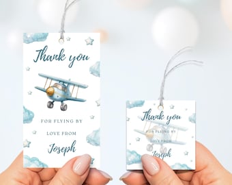 May include: Two square gift tags featuring a light blue aeroplane illustration, clouds, and stars. The tags read "Thank you for flying by, love from Joseph."