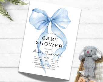 May include: A baby shower invitation with a watercolor blue bow design. The invitation includes the text "Baby Shower" and details for the event, including the honoree's name, date, time, and location. A stuffed bunny and wooden blocks are in the background.