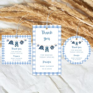 May include: Baby shower gift tags in three shapes: square, rectangular, and circular. Each tag features a blue gingham border and the text "Thank you" with a clothesline of baby clothes. The tags are personalized with names and dates.
